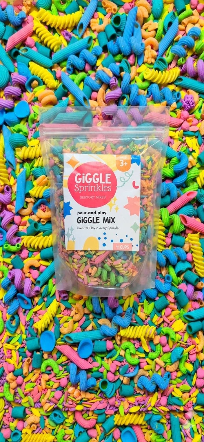 Giggle Mix pour-and-play sensory mix pouch surrounded by colourful pasta sprinkles